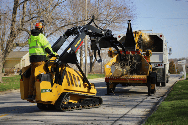 Vermeer Mini Skid Steer an Brush Chipper at work